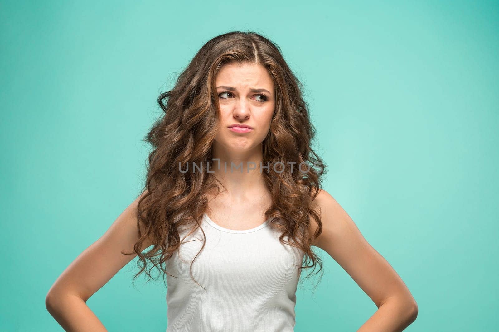 The young woman's portrait with sad emotions at studio