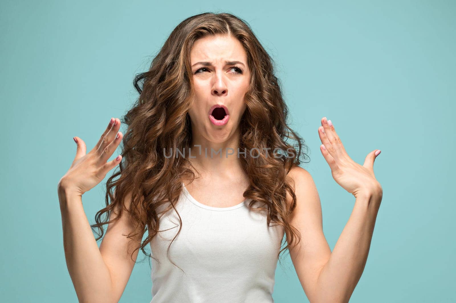 The portrait of disgusted woman on studio background