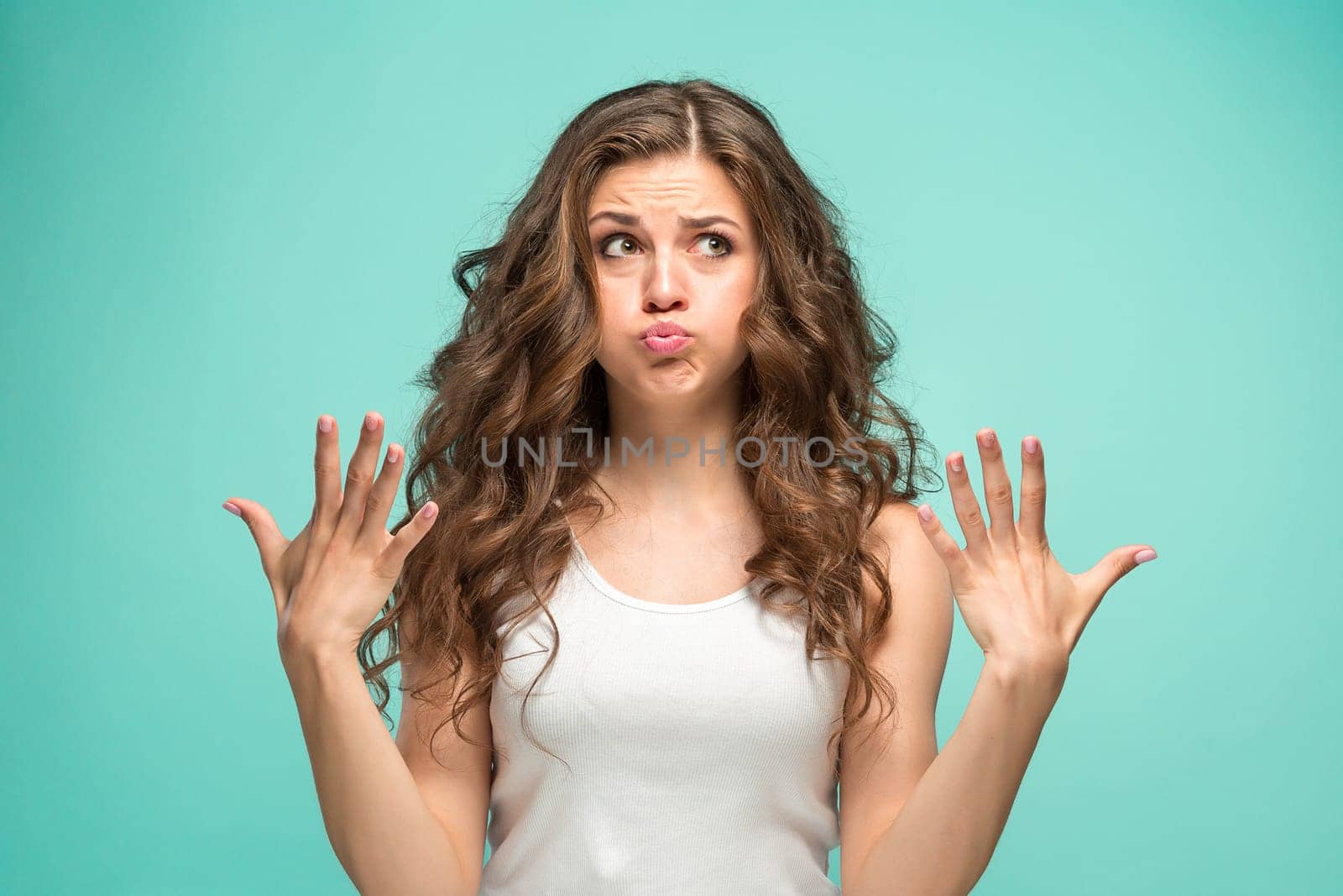The portrait of disgusted woman on studio background