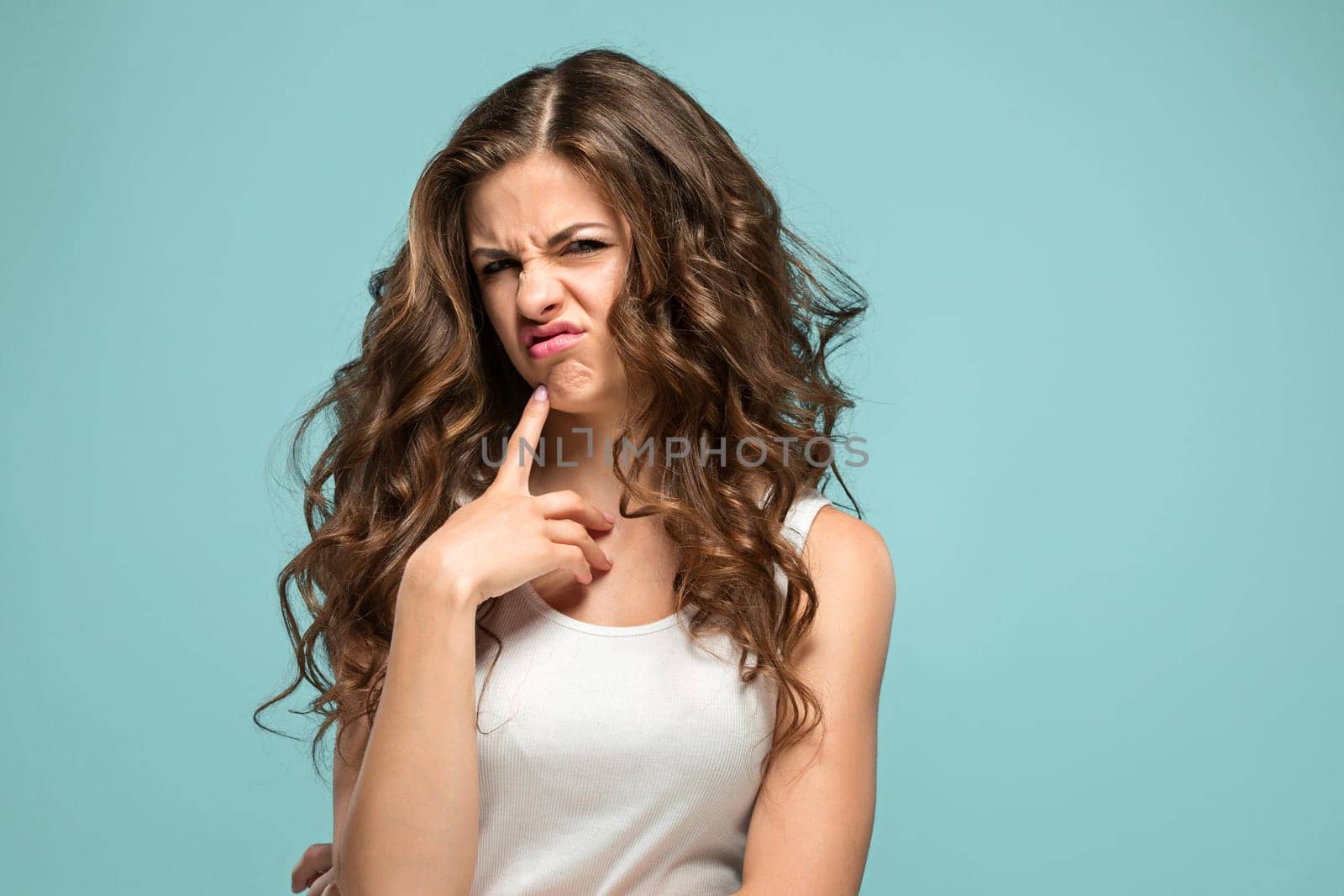 The portrait of disgusted woman on studio background