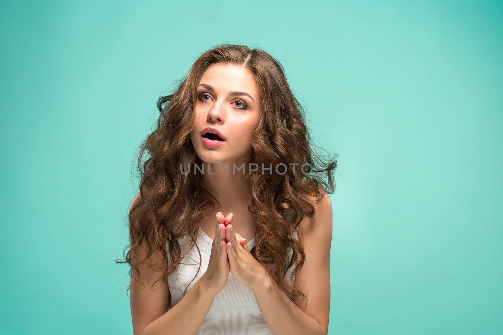 The portrait of young woman with shocked facial expression