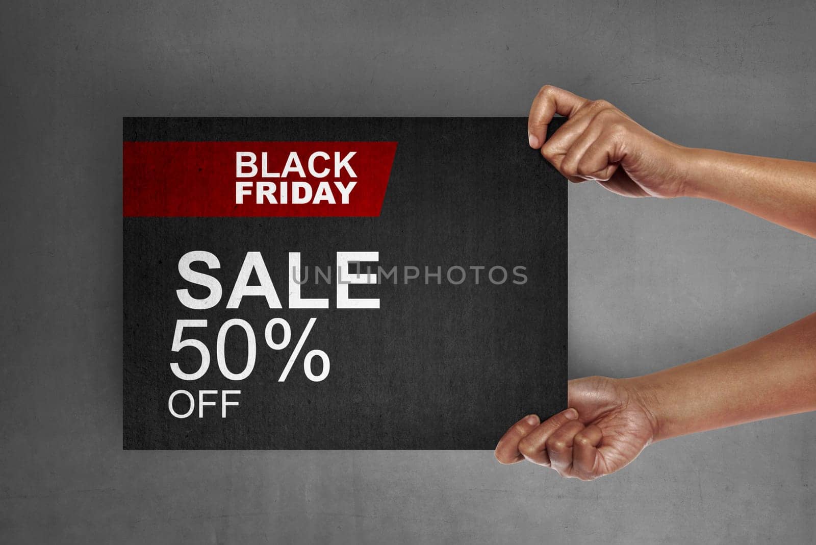 Hand holding signboard with sale discount on Black Friday. Black friday concept
