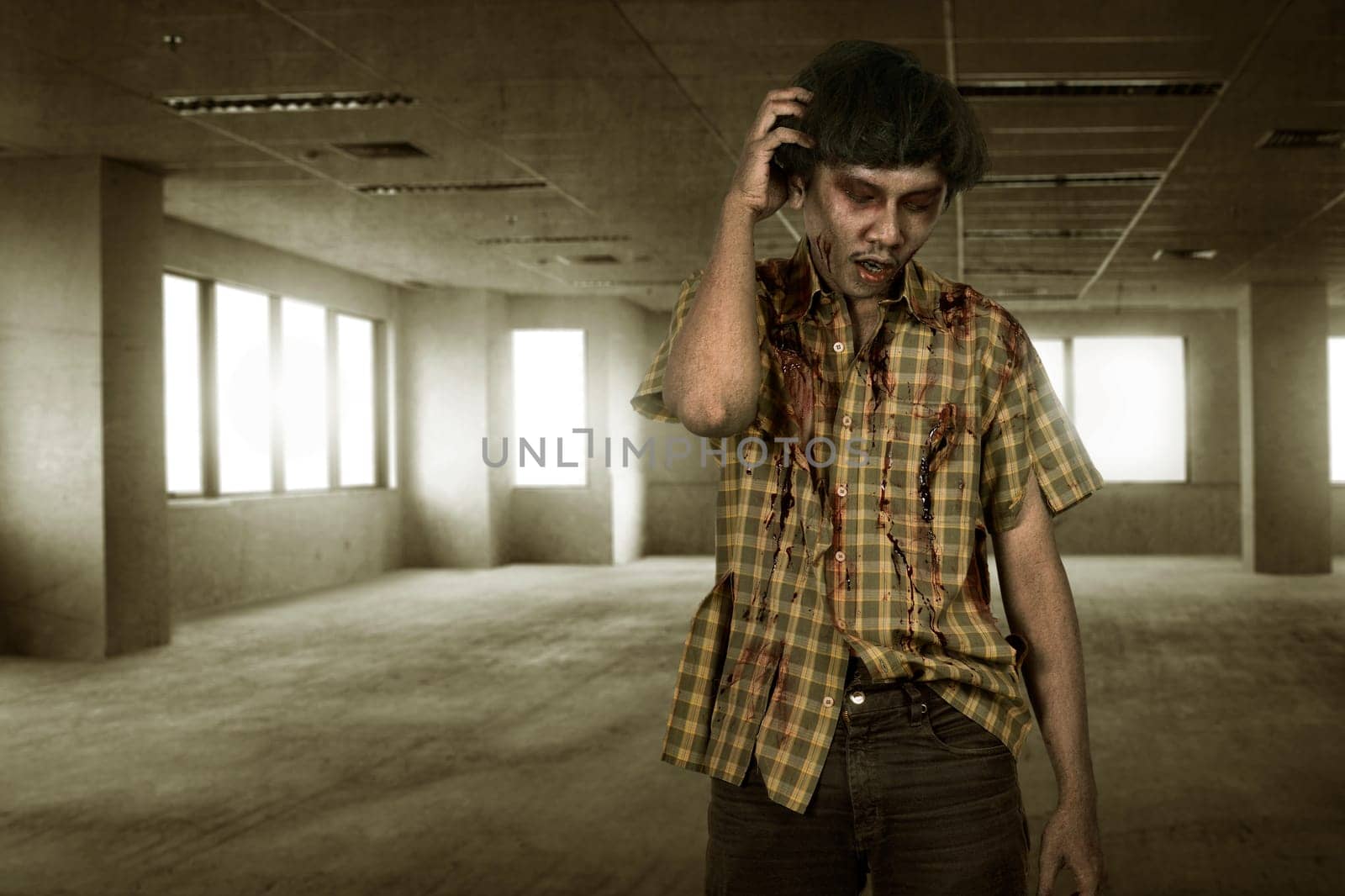 Scary asian zombie man with wounded face standing on the empty room
