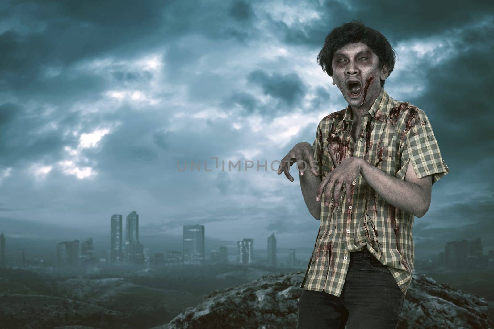 Scary asian zombie man with open mouth standing with dramatic sky background