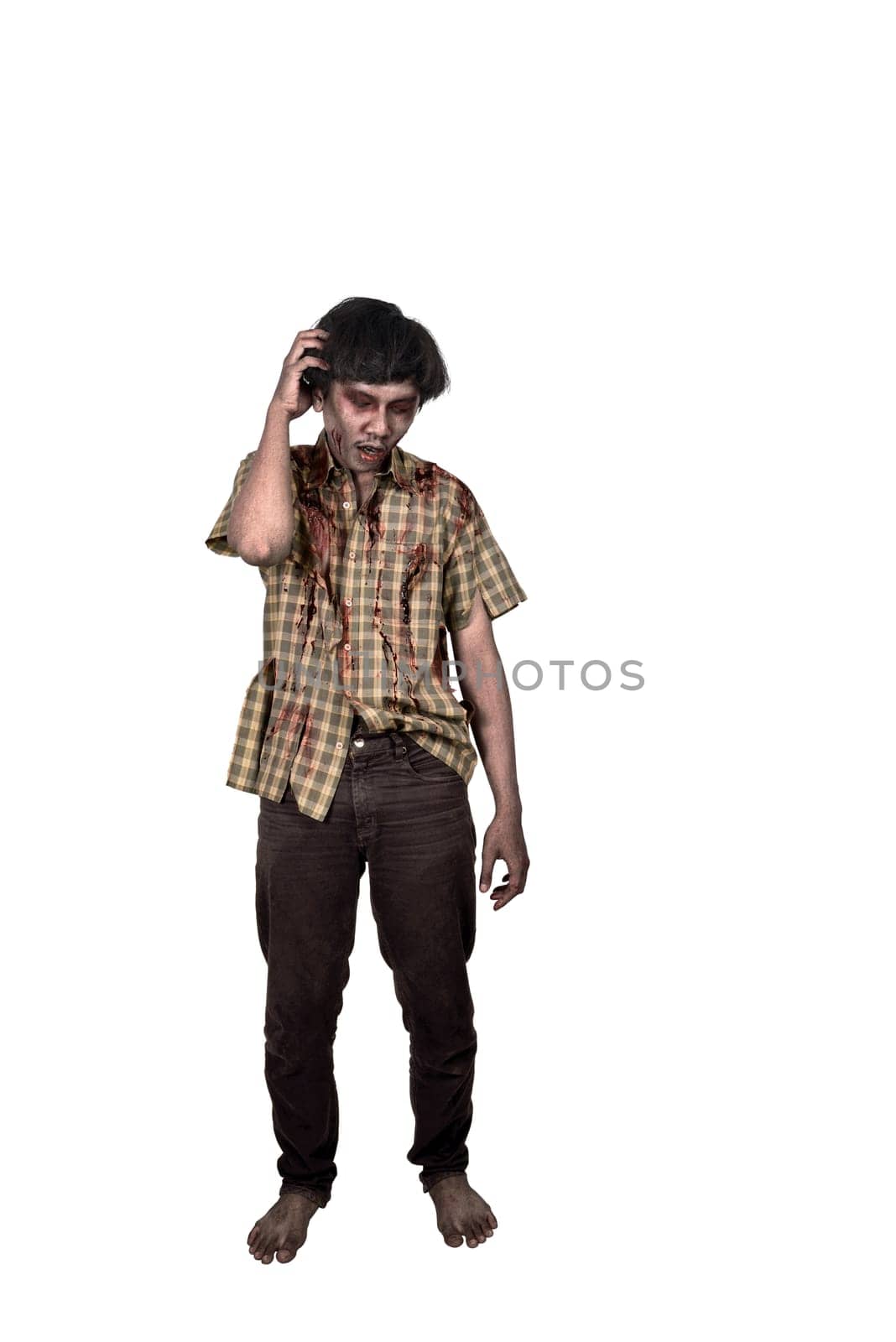 Portrait of asian zombie man with confused expression standing isolated over white background