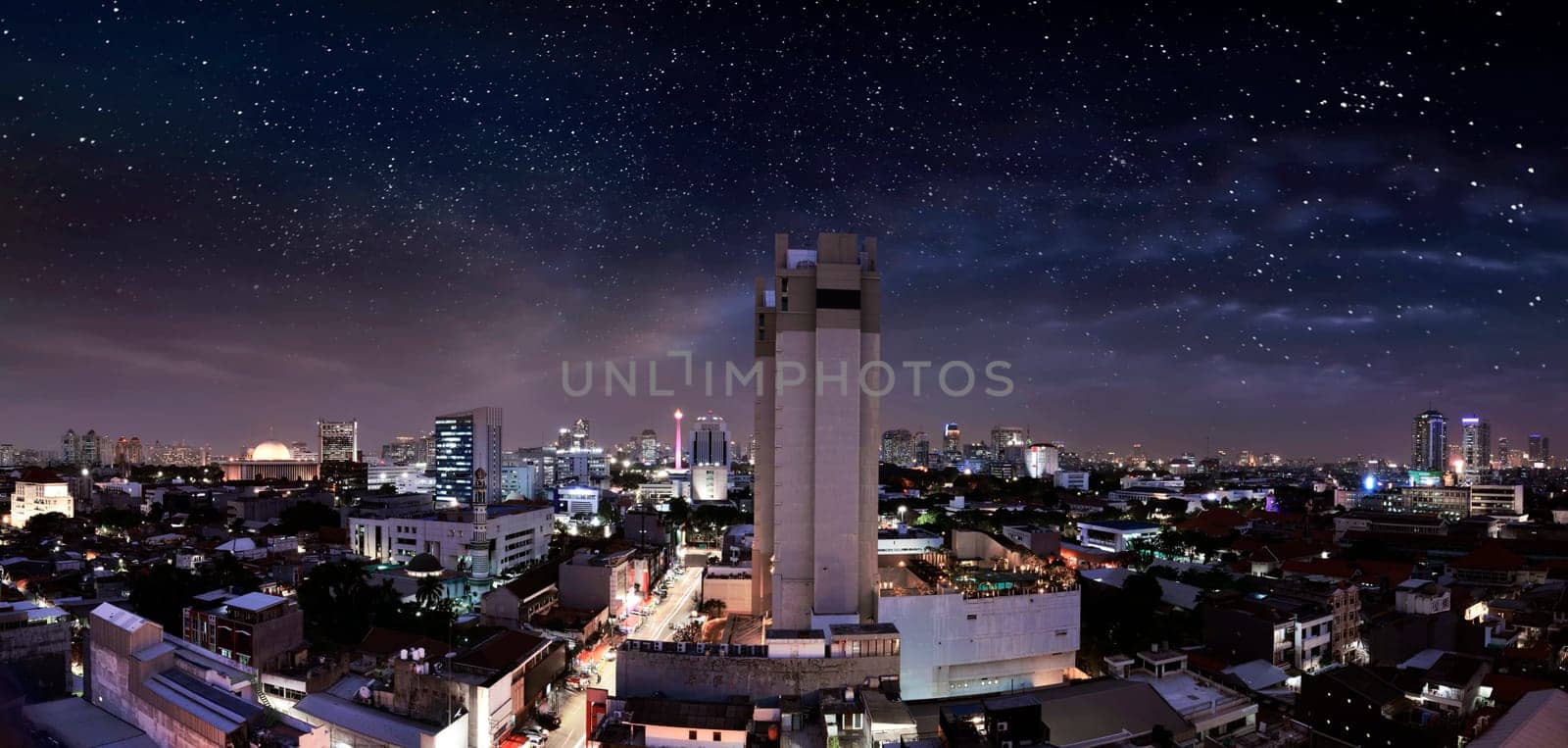 Portrait of modern jakarta city with skyscrapers and star on sky at night