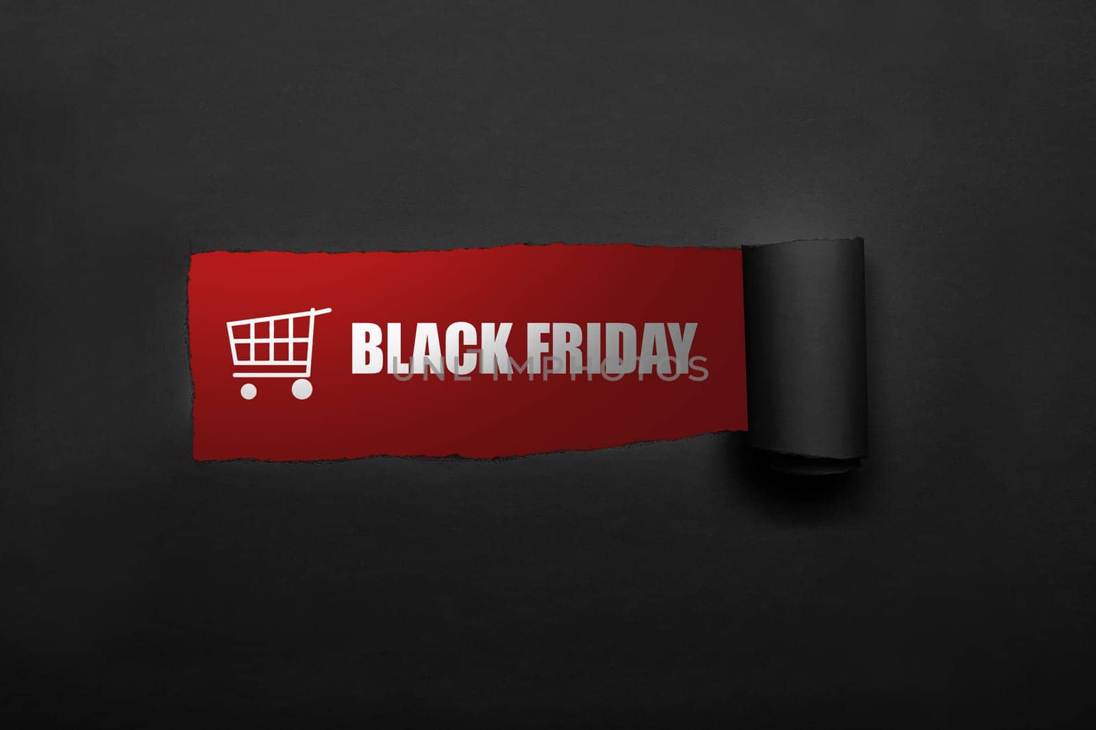 Shopping cart and Black Friday text on the paper torn