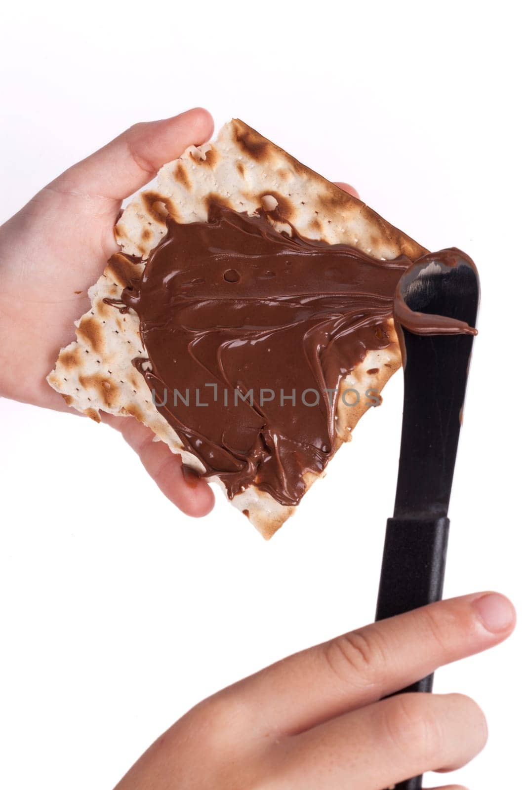 Child hand Macking Chocolate With Matzah for Passover