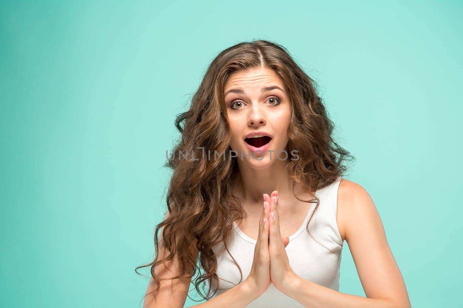 The portrait of alarmed young woman with shocked facial expression