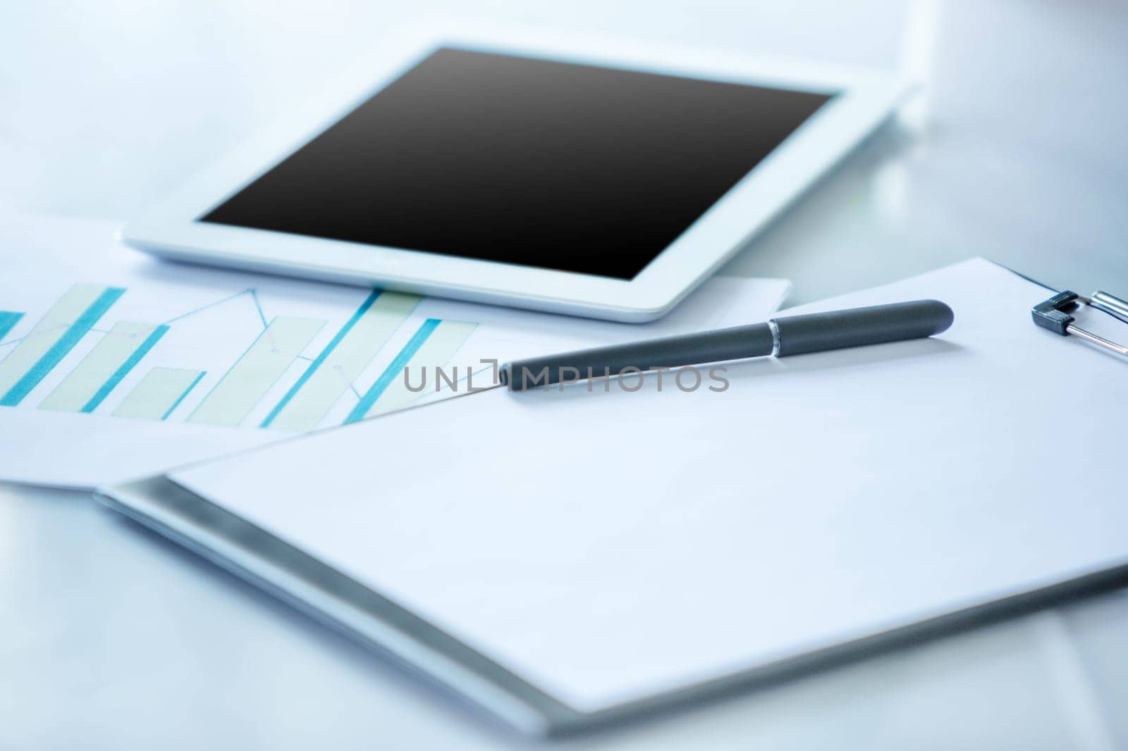 The tipical office desktop with pc, pens, notebook, laptop