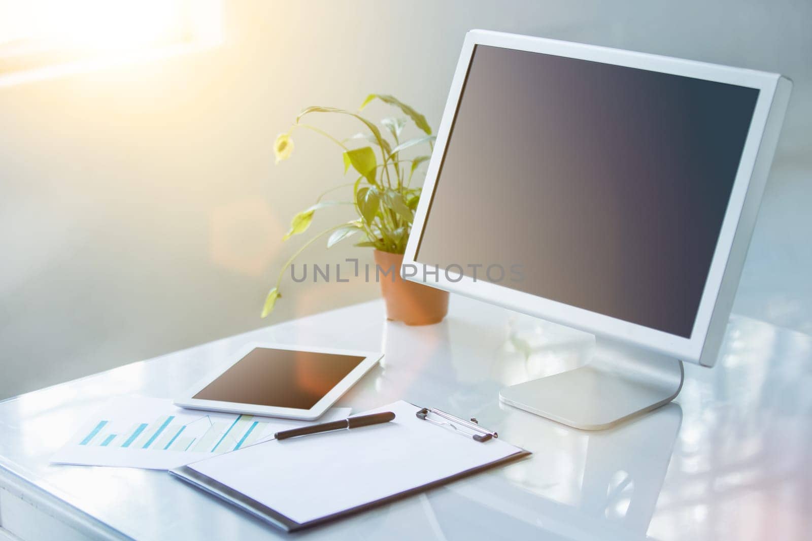 The tipical office desktop with pc, pens, notebook, laptop