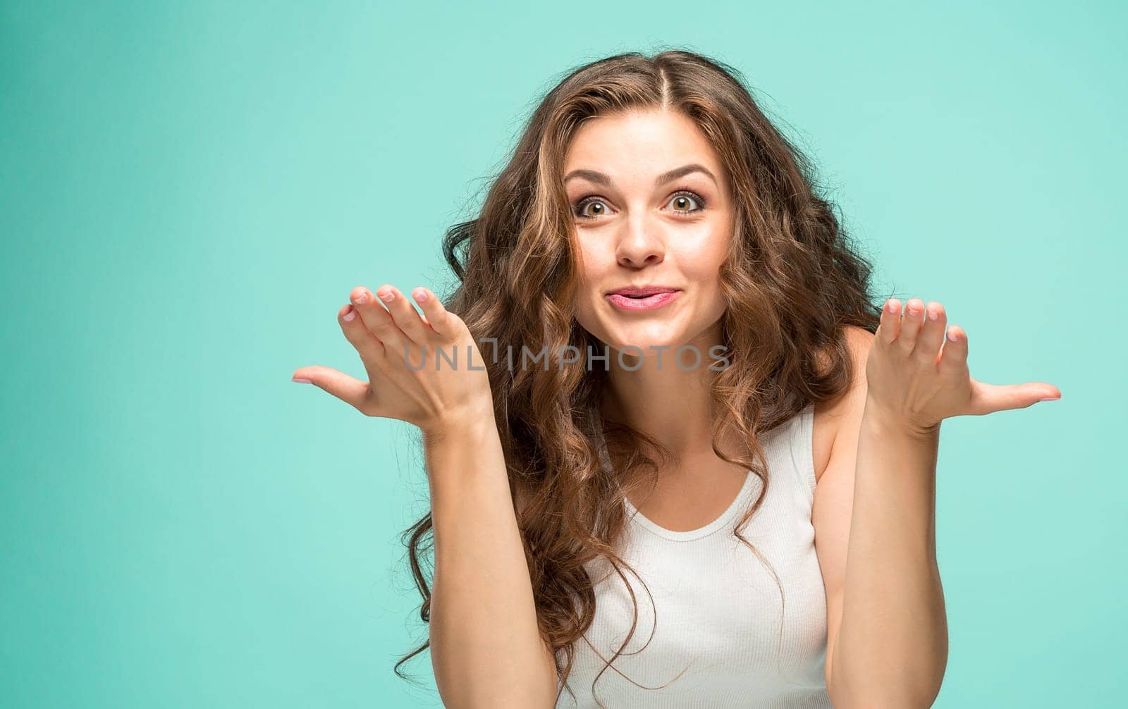 The portrait of alarmed young woman with shocked facial expression