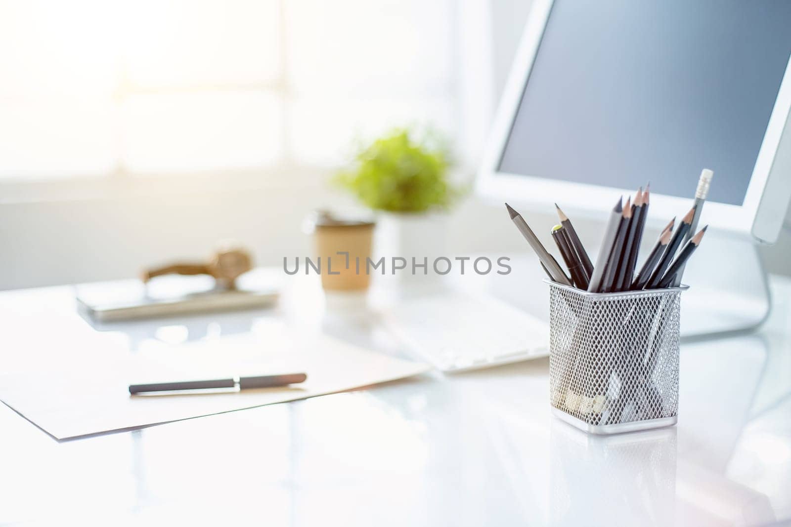 The tipical office desktop with pc, pens, notebook, laptop