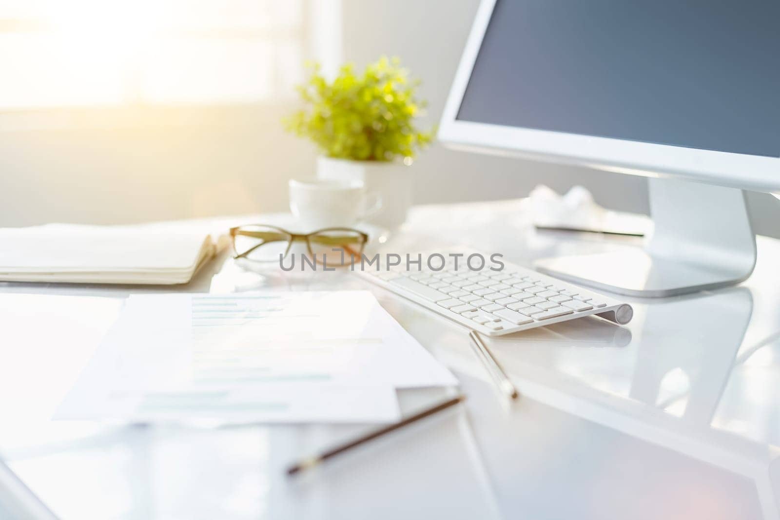 The tipical office desktop with pc, pens, notebook, laptop