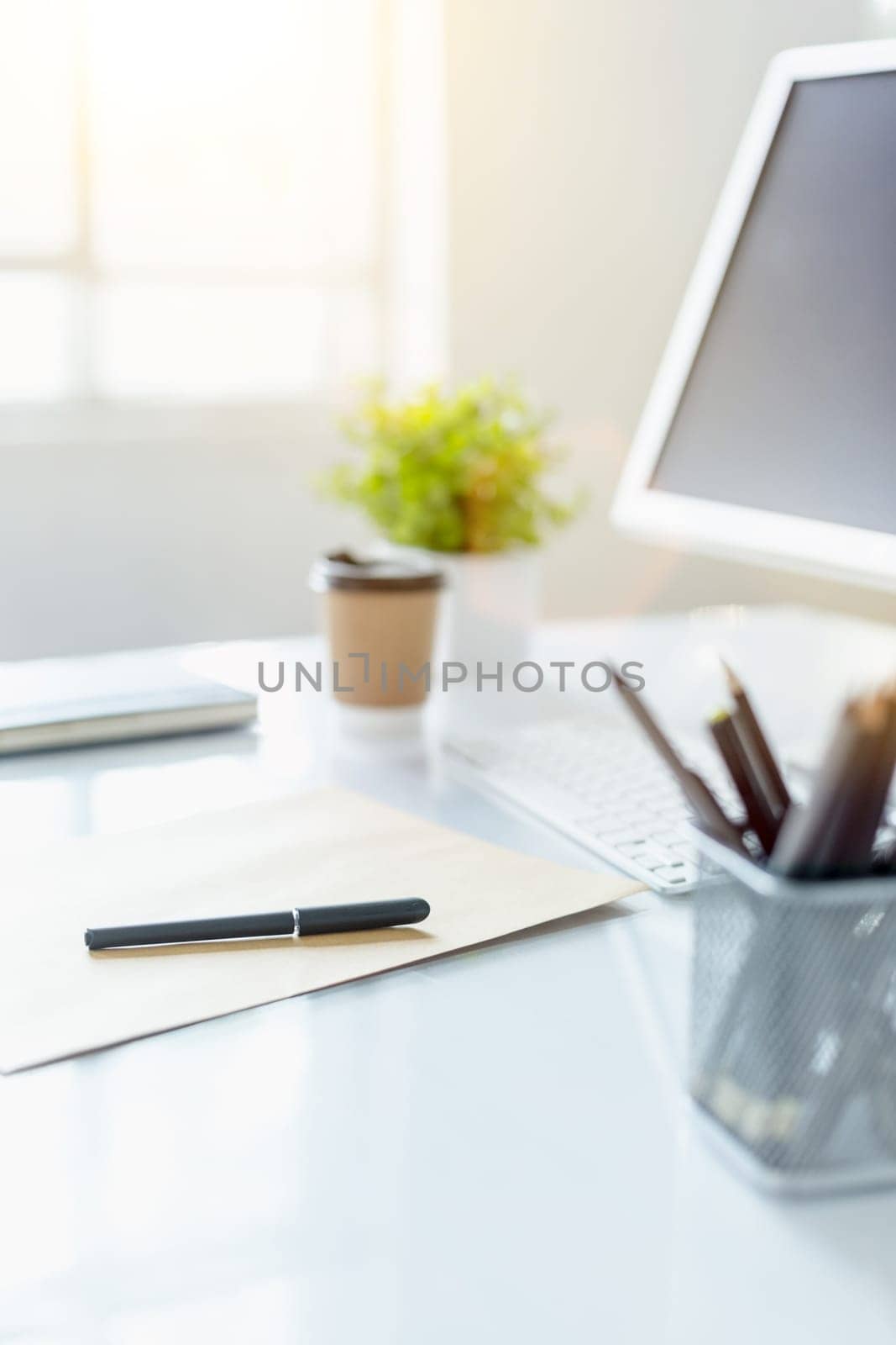 The tipical office desktop with pc, pens, notebook, laptop