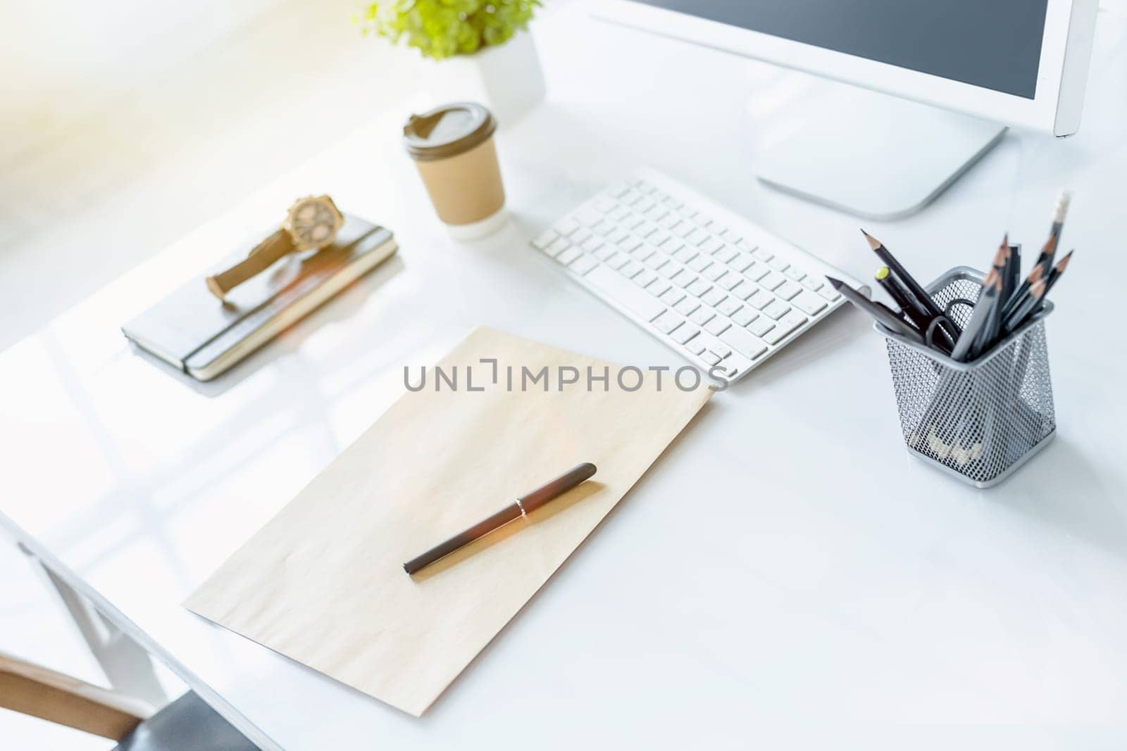 The tipical office desktop with pc, pens, notebook, laptop