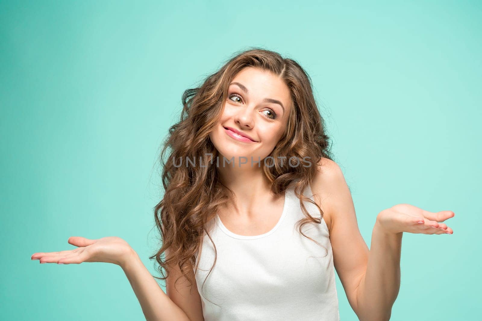 The young woman's portrait with happy emotions on gray background
