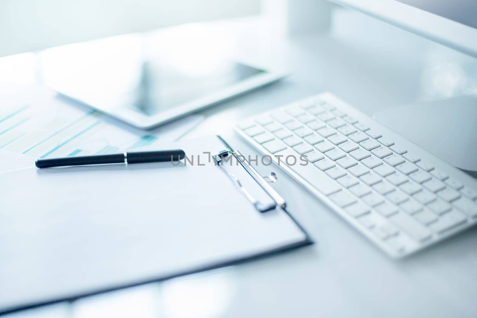 The tipical office desktop with pc, pens, notebook, laptop