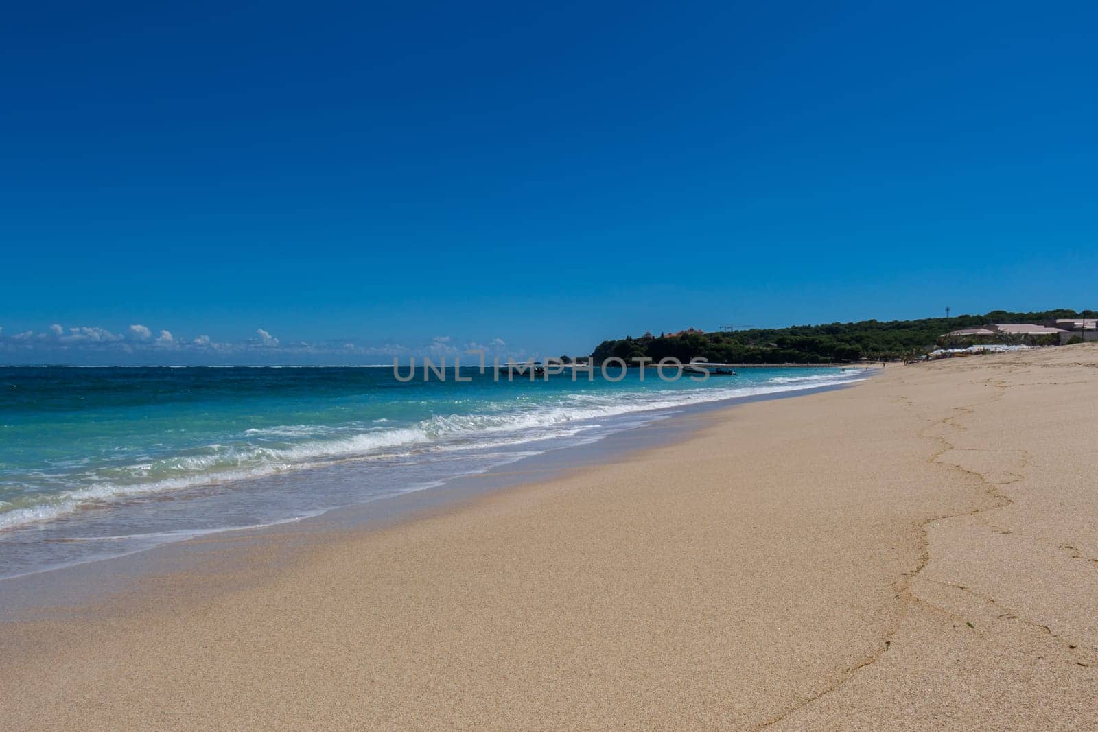 Beautiful secluded sandy beach in the Caribbean with white sand and blue sky as in paradise