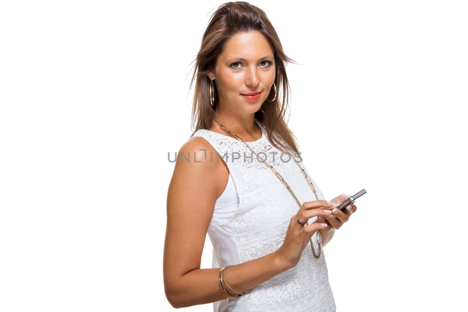 Young attractive woman reacts to a text message on her phone smartphone with open dark hair with text clearance isolated freeholder