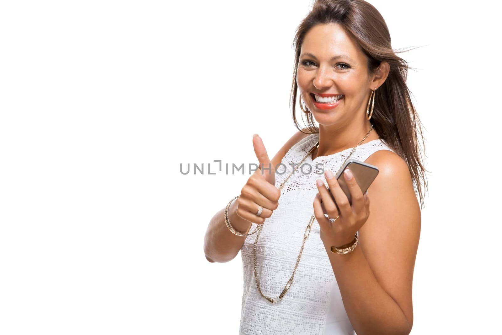 Young attractive woman reacts to a text message on her phone smartphone with open dark hair with text clearance isolated freeholder