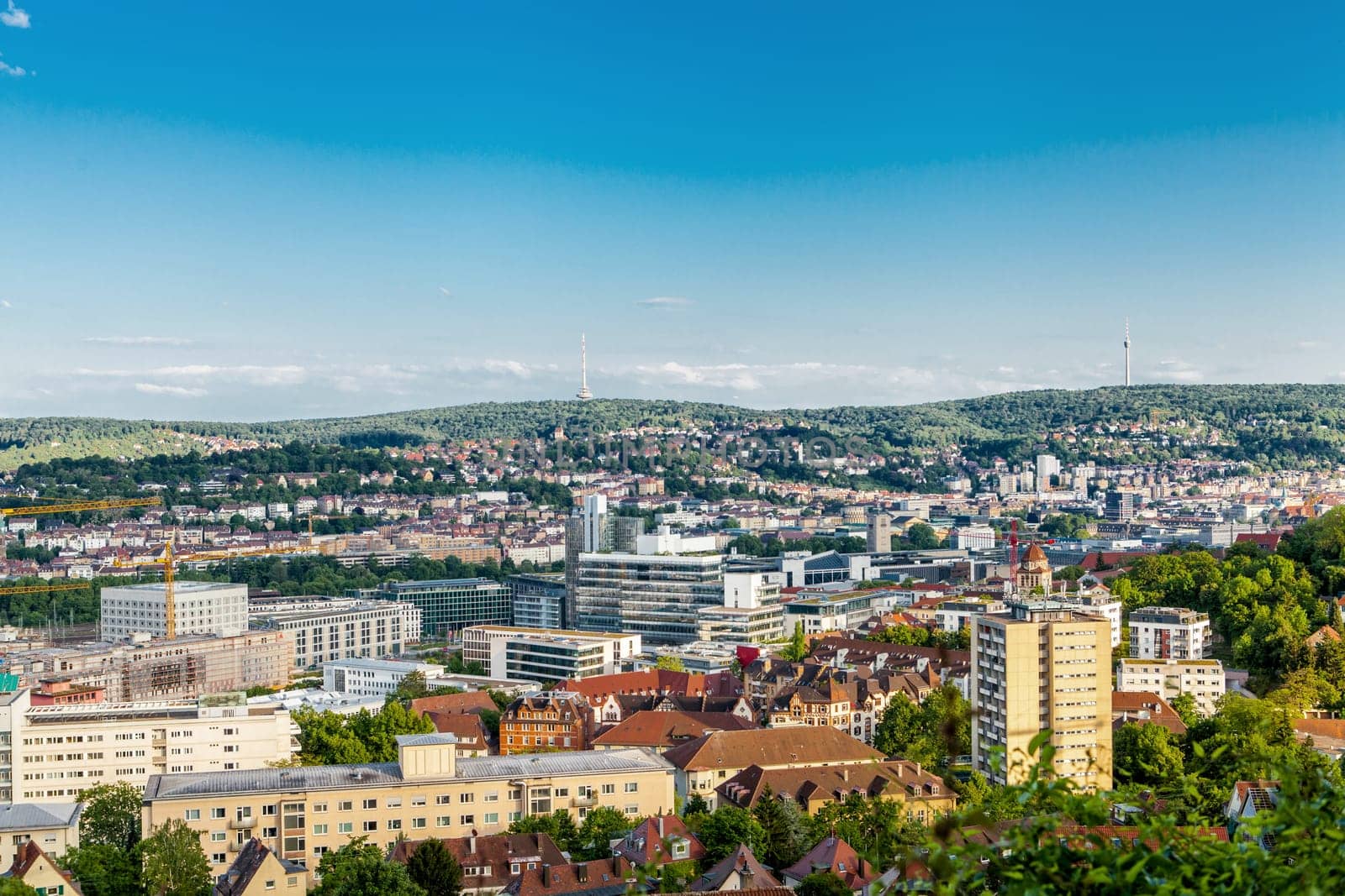 Picturesque view of Stuttgart Germany the modern skyscrapers under the traditional historical architecture overlooking the surrounding hills on a sunny day