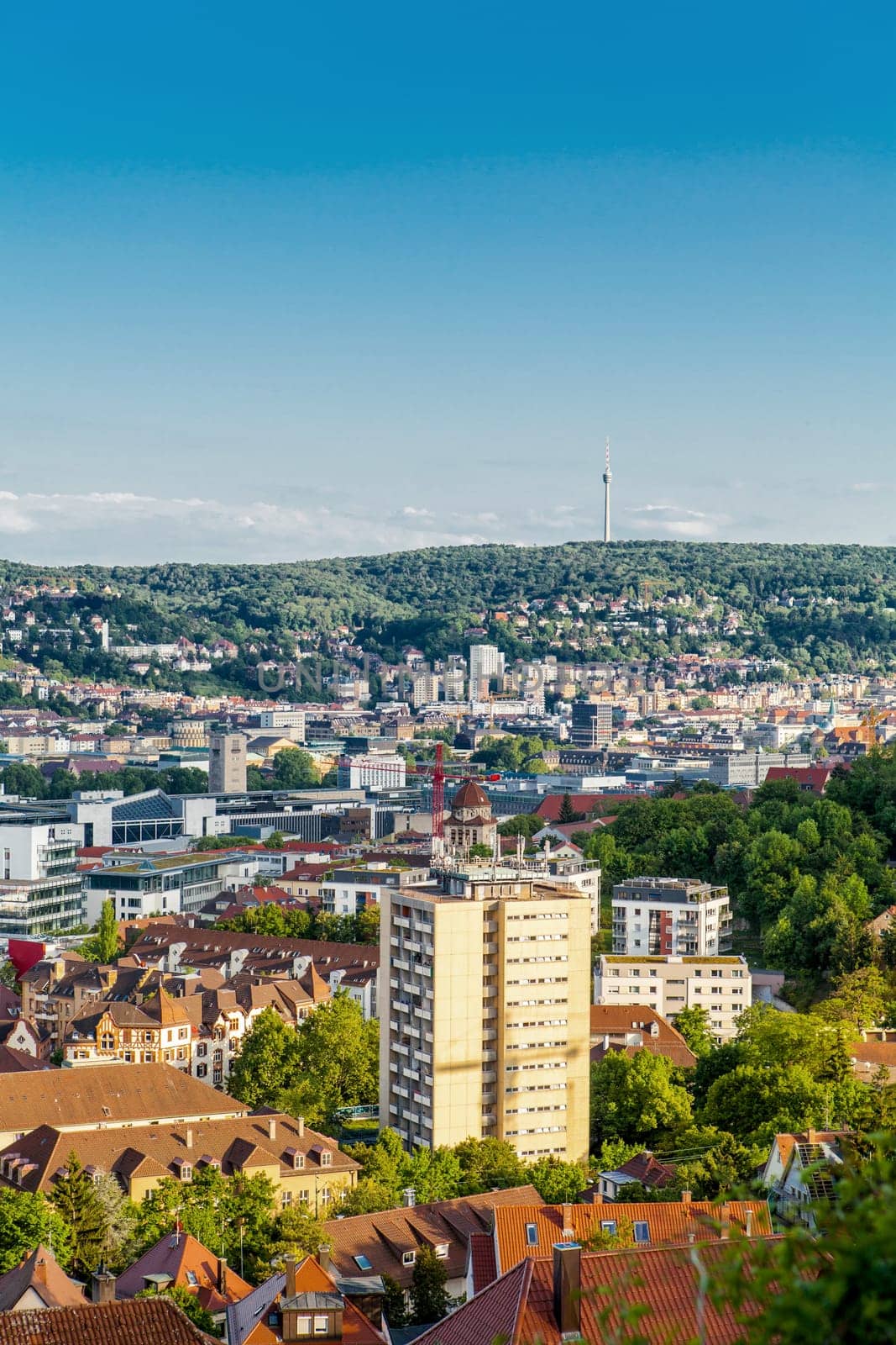 Picturesque view of Stuttgart Germany the modern skyscrapers under the traditional historical architecture overlooking the surrounding hills on a sunny day