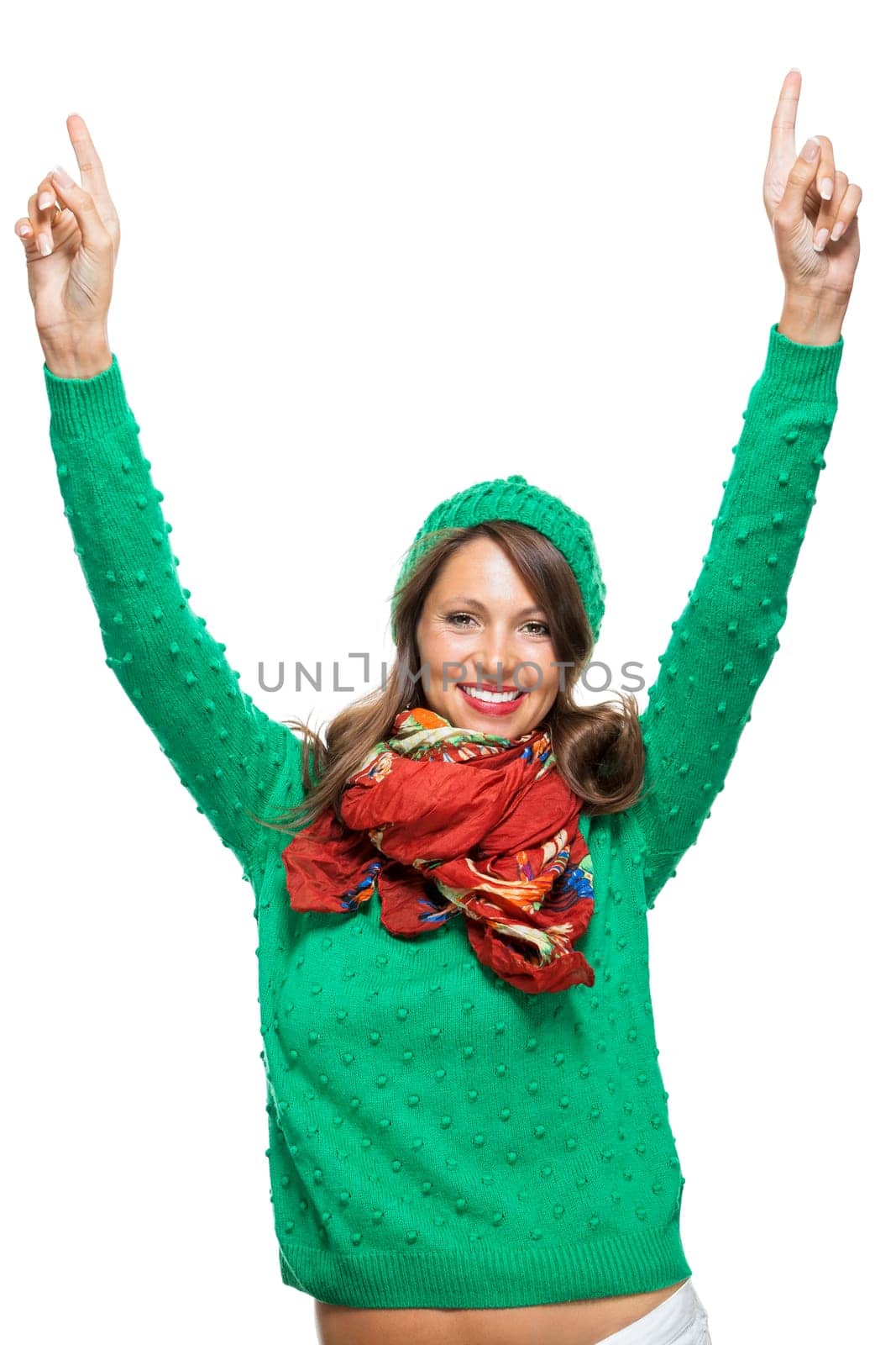 Young brunette woman with green wool hat shows cheering in the air isolated on white background