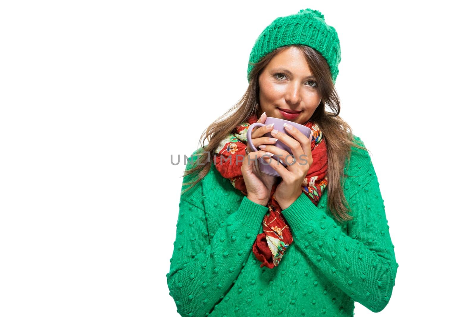 Brunette young woman with large coffee cup and green wool hat isolated against white background