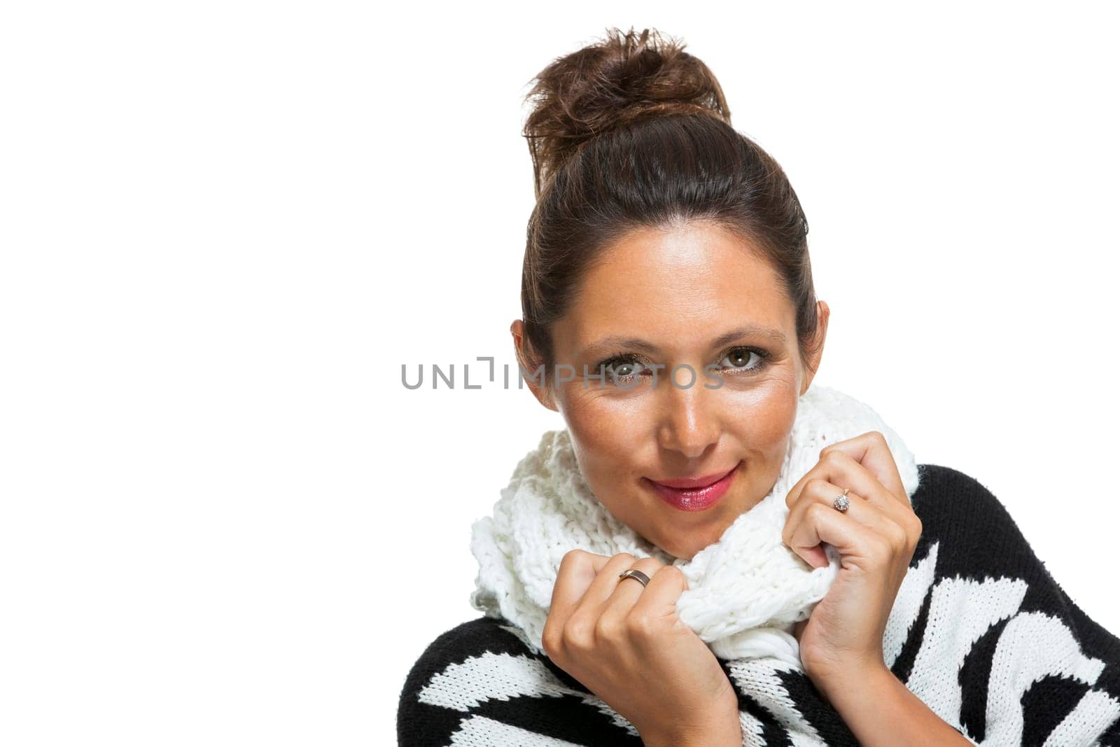 attractive young woman with white wool hat and knitted sweater scarf gloves with dark hair laughing isolated on white background