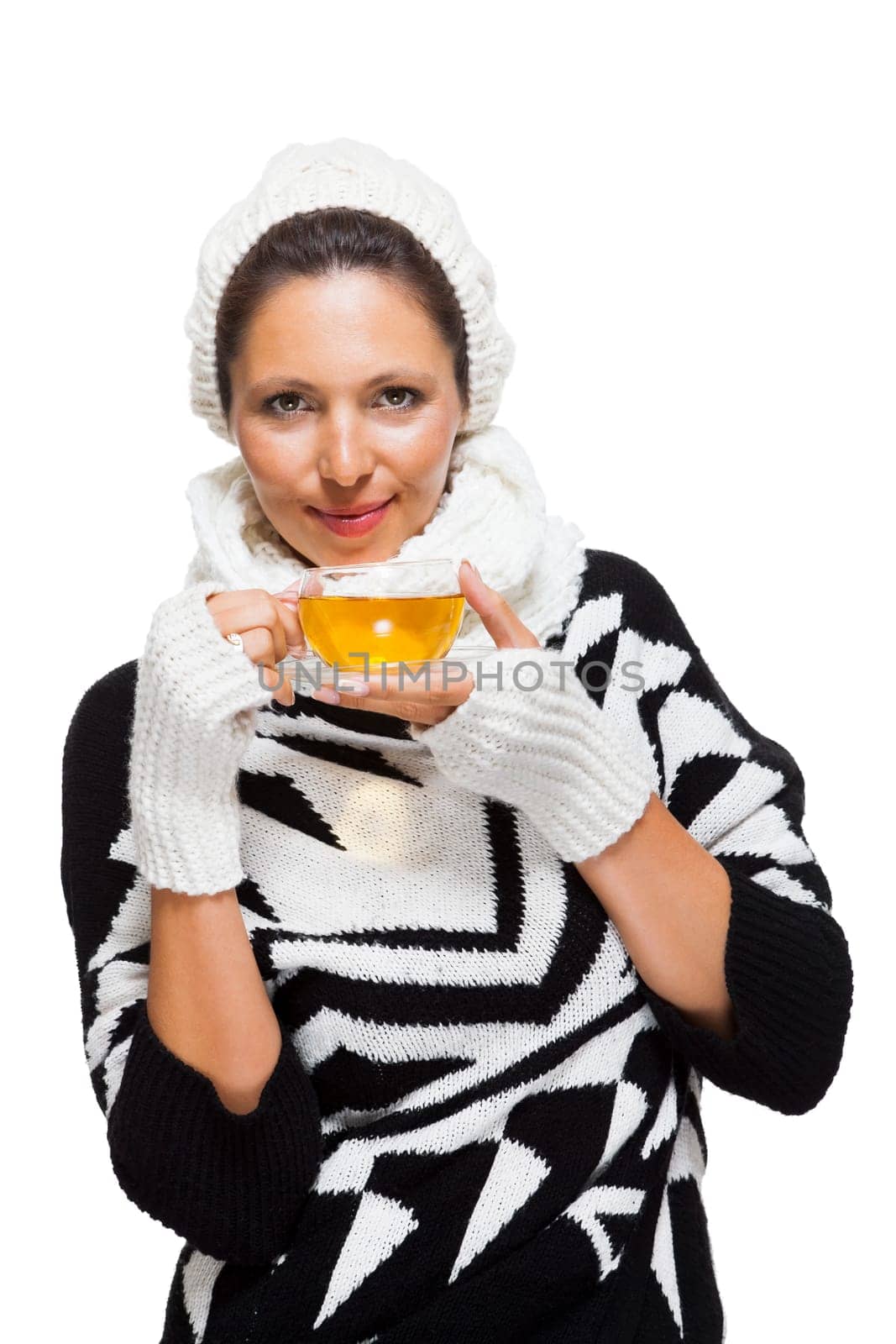 Young brunette woman with white wool lyane drinks a cup of tea to warm up isolated on white background