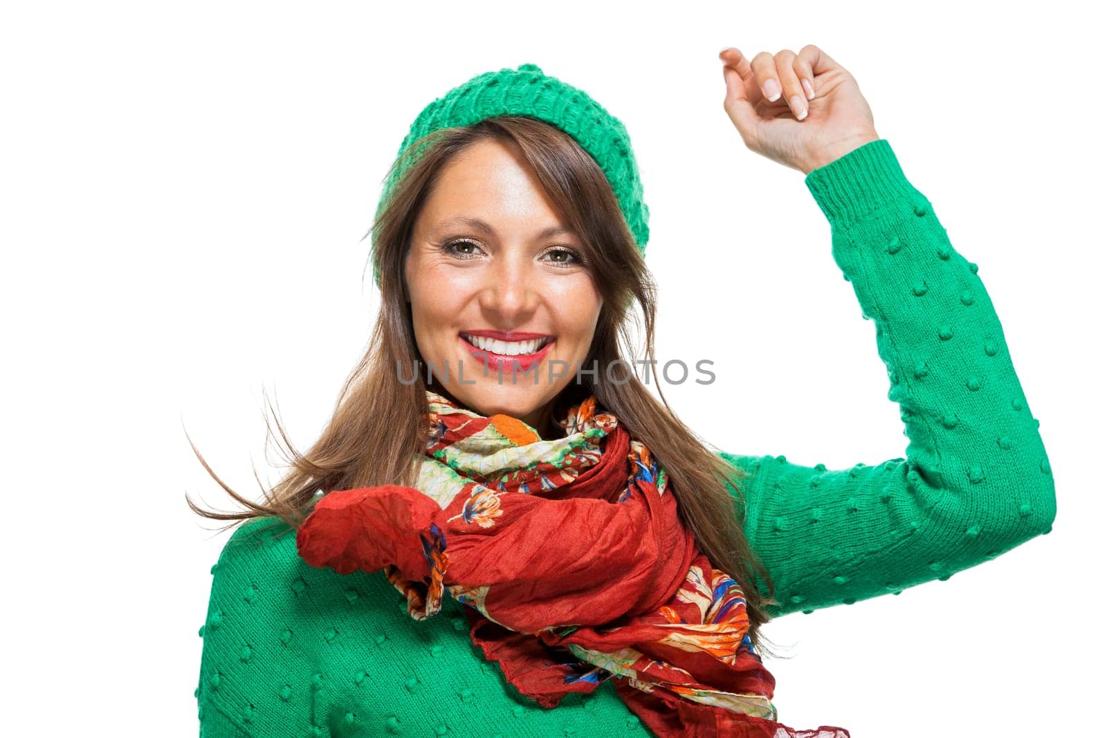 Young brunette woman with green wool hat shows cheering in the air isolated on white background