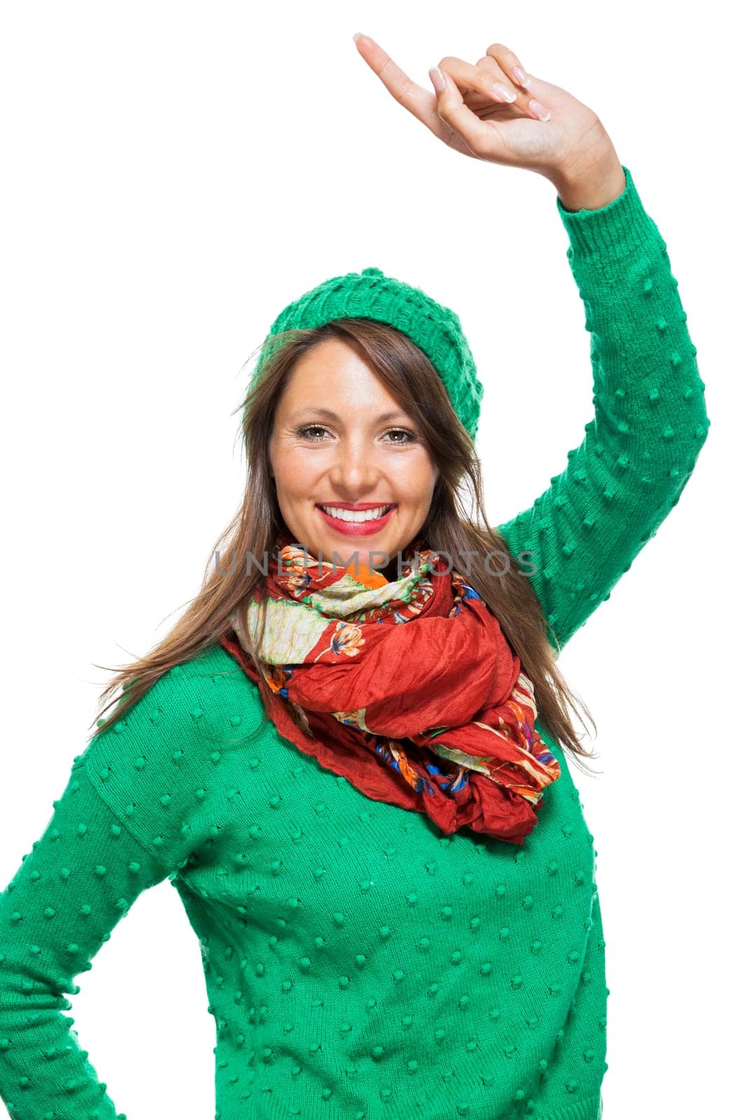 Young brunette woman with green wool hat shows cheering in the air isolated on white background