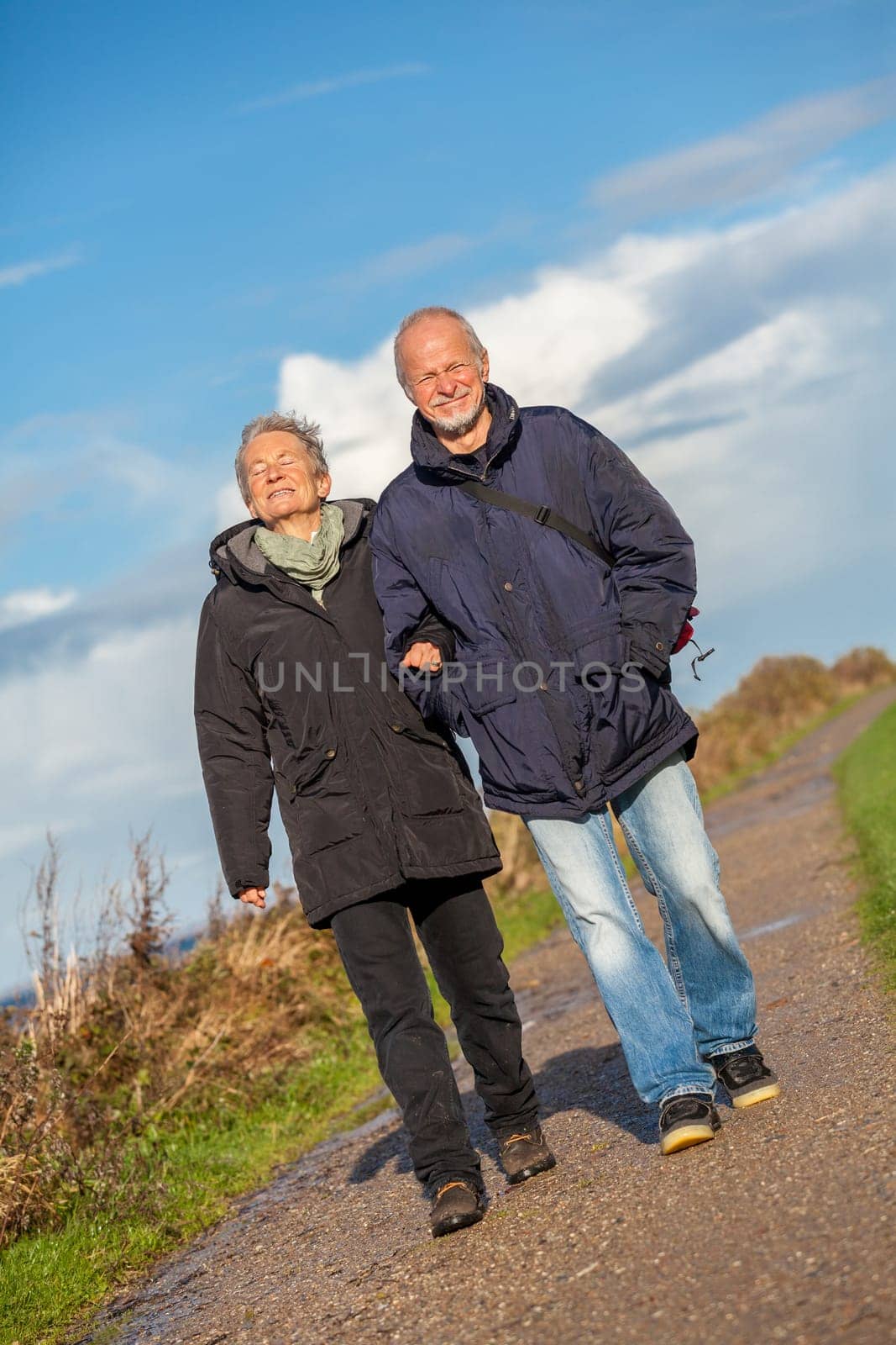 older happy couple makes a beach walk in autumn baltic sea landscape sea
