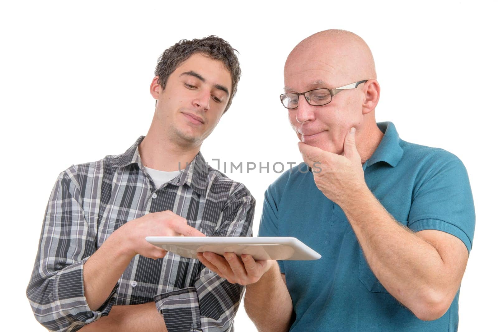 a son explains to his father the digital tablet