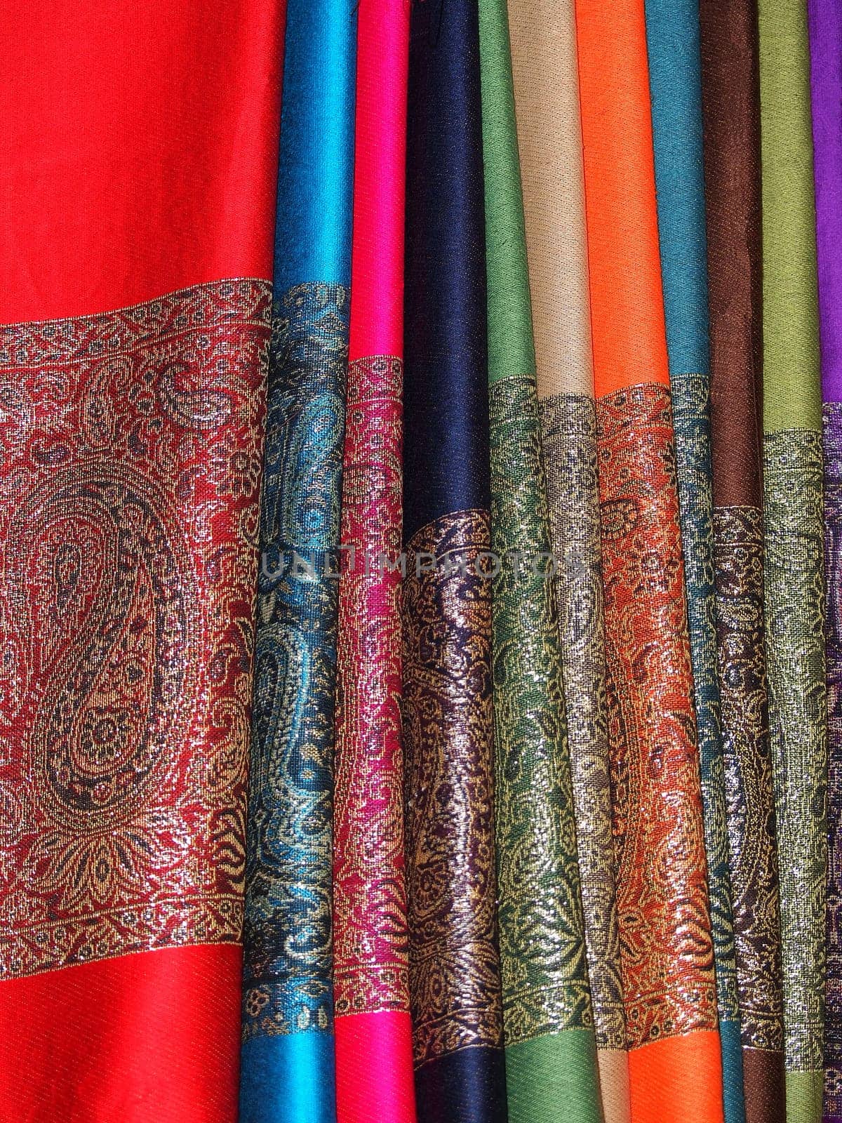 Pile of gentle folded shawls (scarfs)hanging at the market in Marrakesh