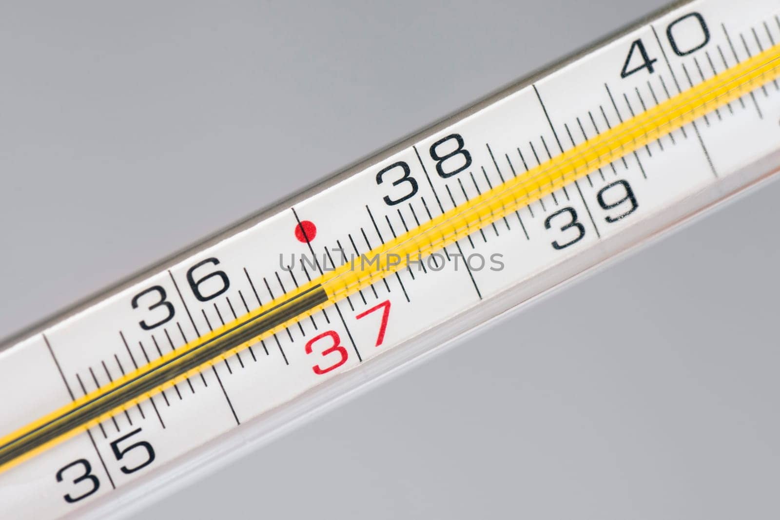Thermometer shows 37 celsius, healthy human temperature.