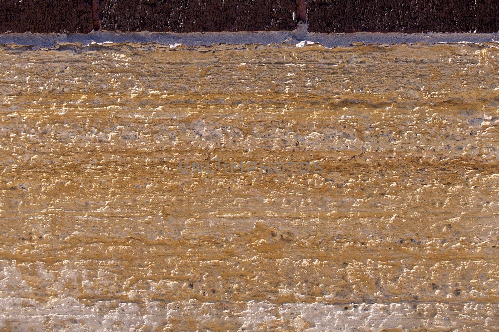 Old limestone block as part of a building foundation