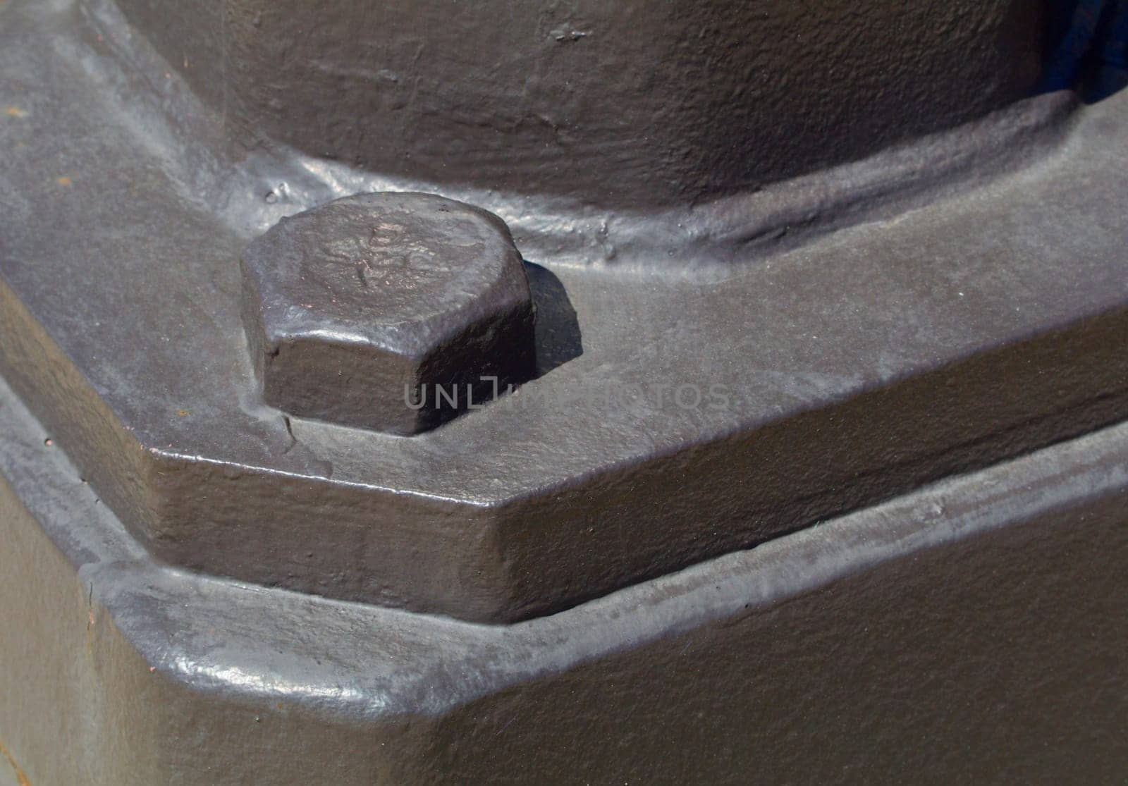 Large painted bolt head showing holding piece in place