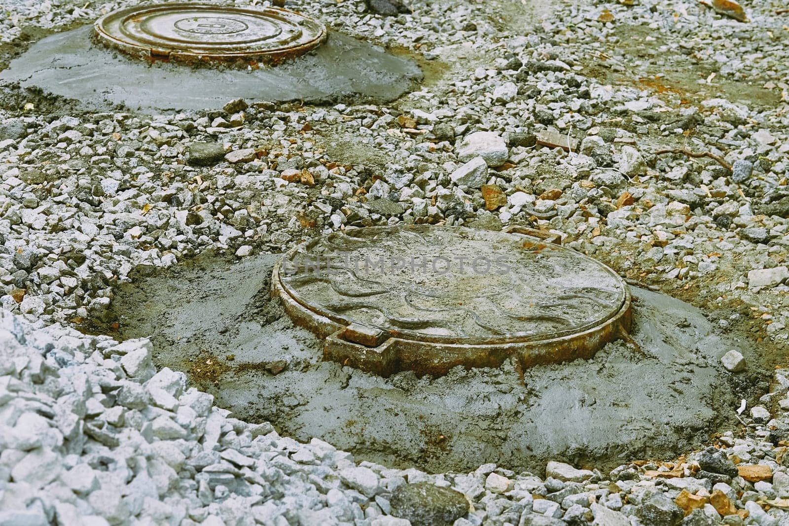 a small covered opening in a floor, pavement, or other surface to allow a person to enter