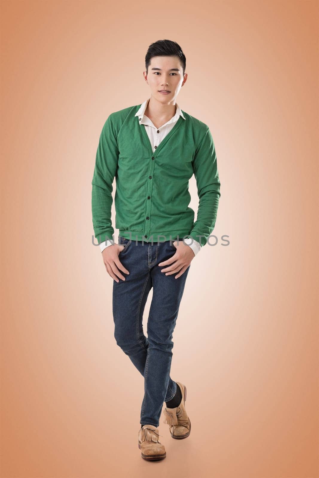 Handsome young Asian man with sweater, full length portrait isolated.