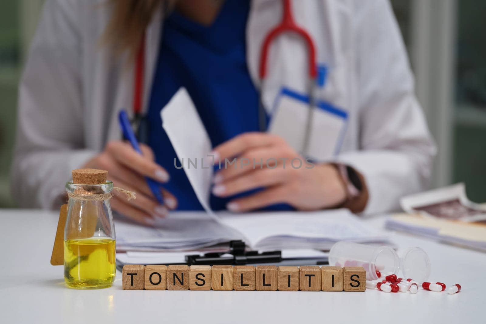 A qualified doctor meticulously studies various medical paperwork with a specific focus on tonsillitis and its remedies
