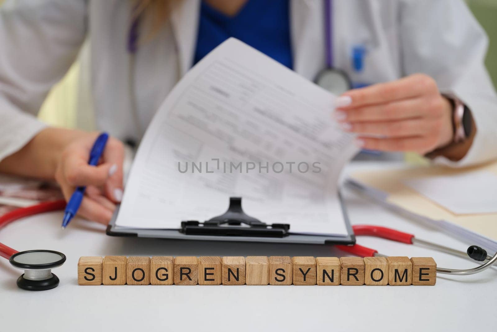 A dedicated healthcare professional actively studying Sjogrens syndrome through detailed patient documents