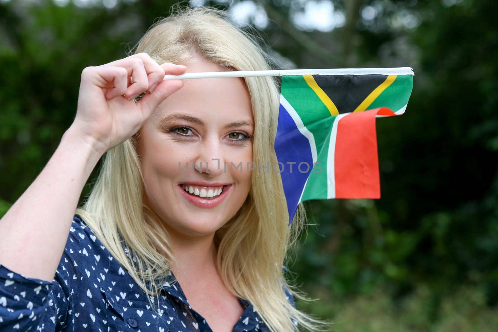Pretty young lady waving the South African flag