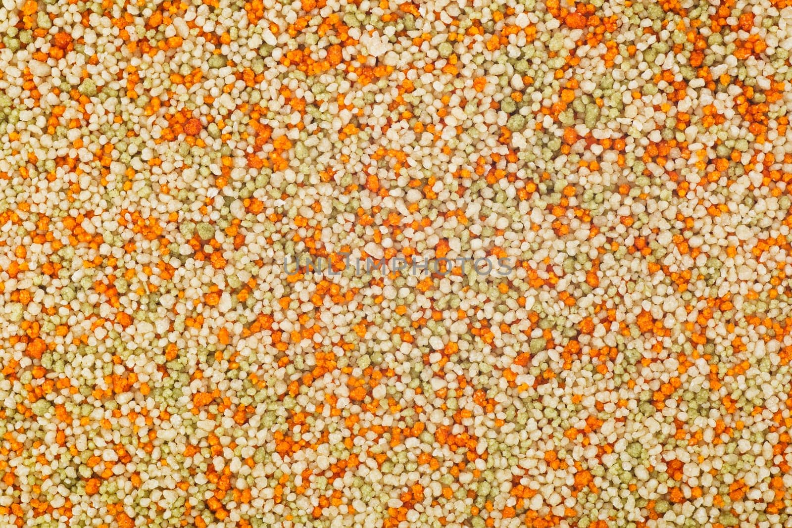 Tricolor couscous food texture or background, with tomato and spinach flavor