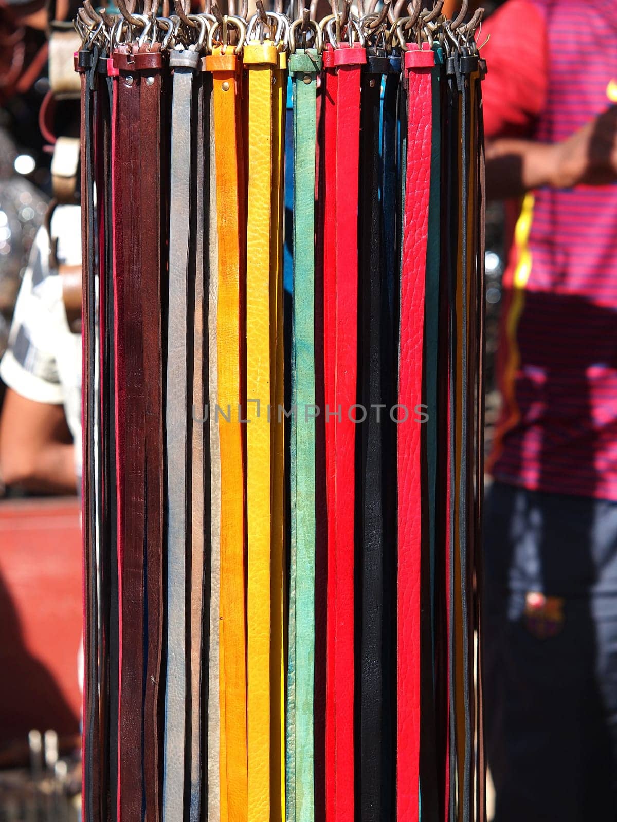 A collection of unbranded belts on a market stand in Marrakech