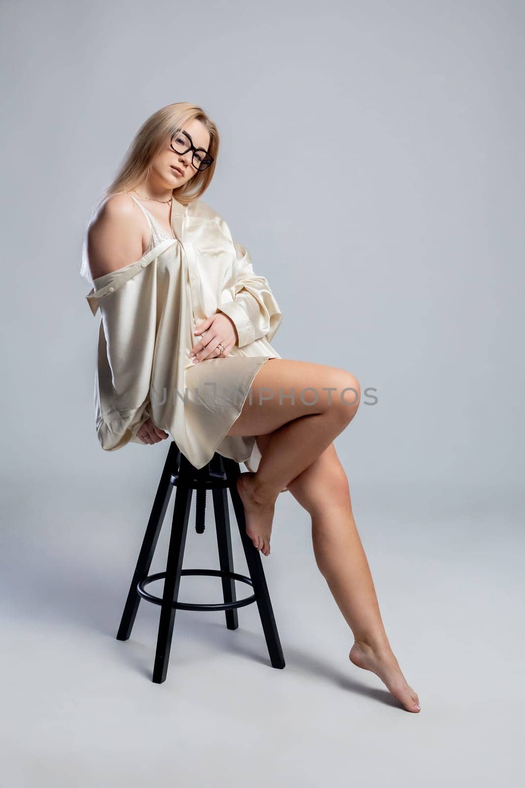 A captivating portrait showcasing a woman dressed in a soft outfit, beautifully exuding elegance and confidence