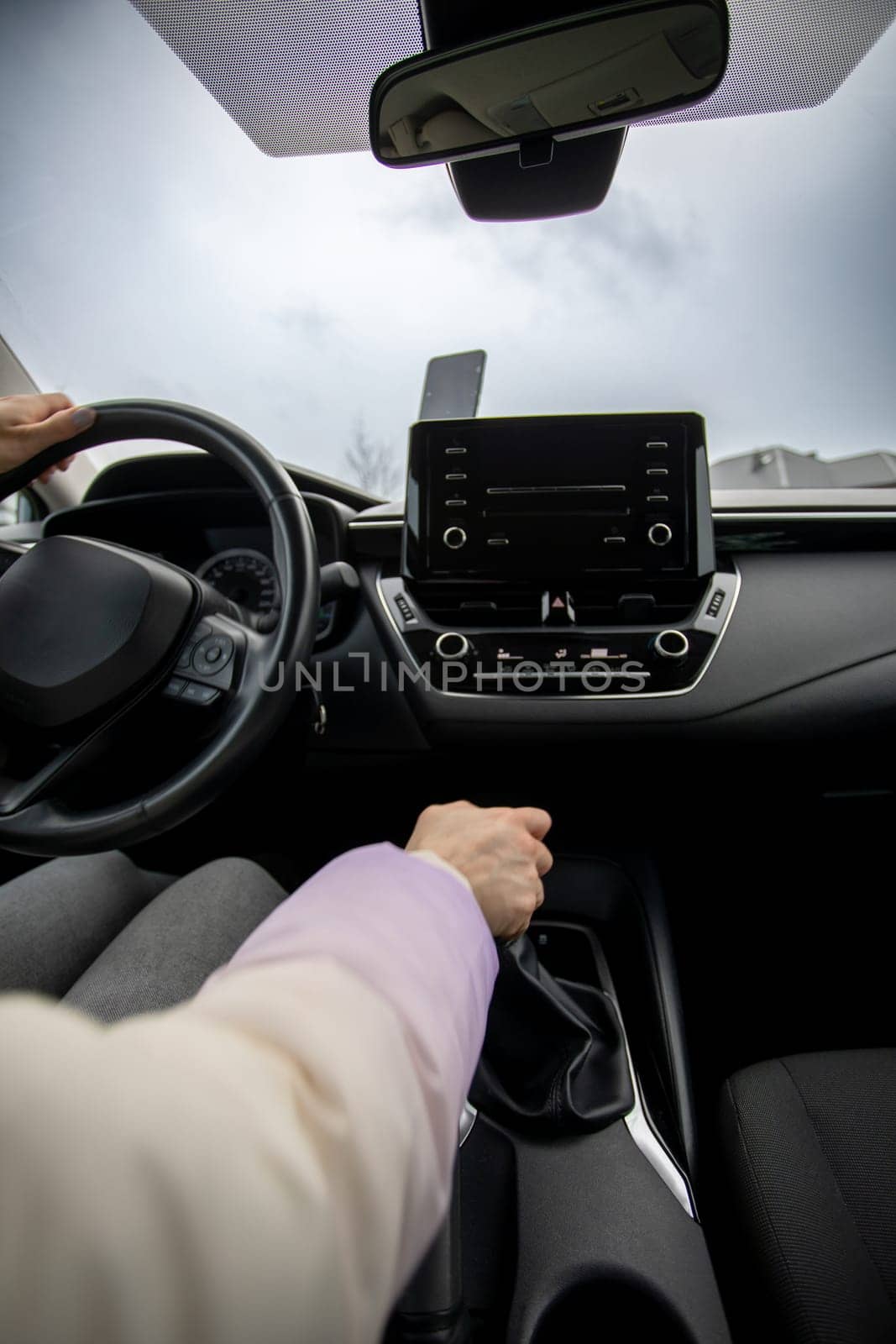 A drivers perspective showcases a modern car interior, complete with a sleek and advanced infotainment system
