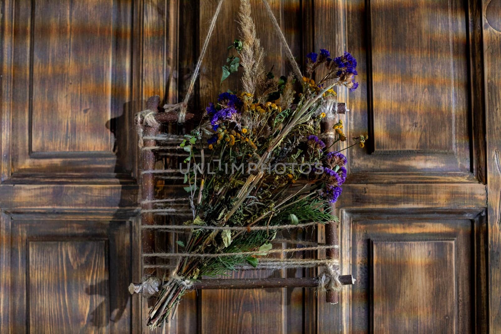 Charming dried wildflowers, beautifully arranged on a rustic wooden door, create a lovely touch for the decor