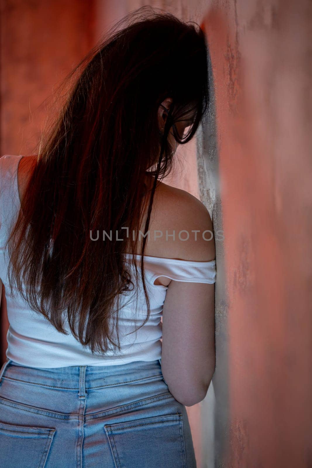 A young woman deeply reflects on her thoughts and feelings, showcasing profound emotion in a serene environment